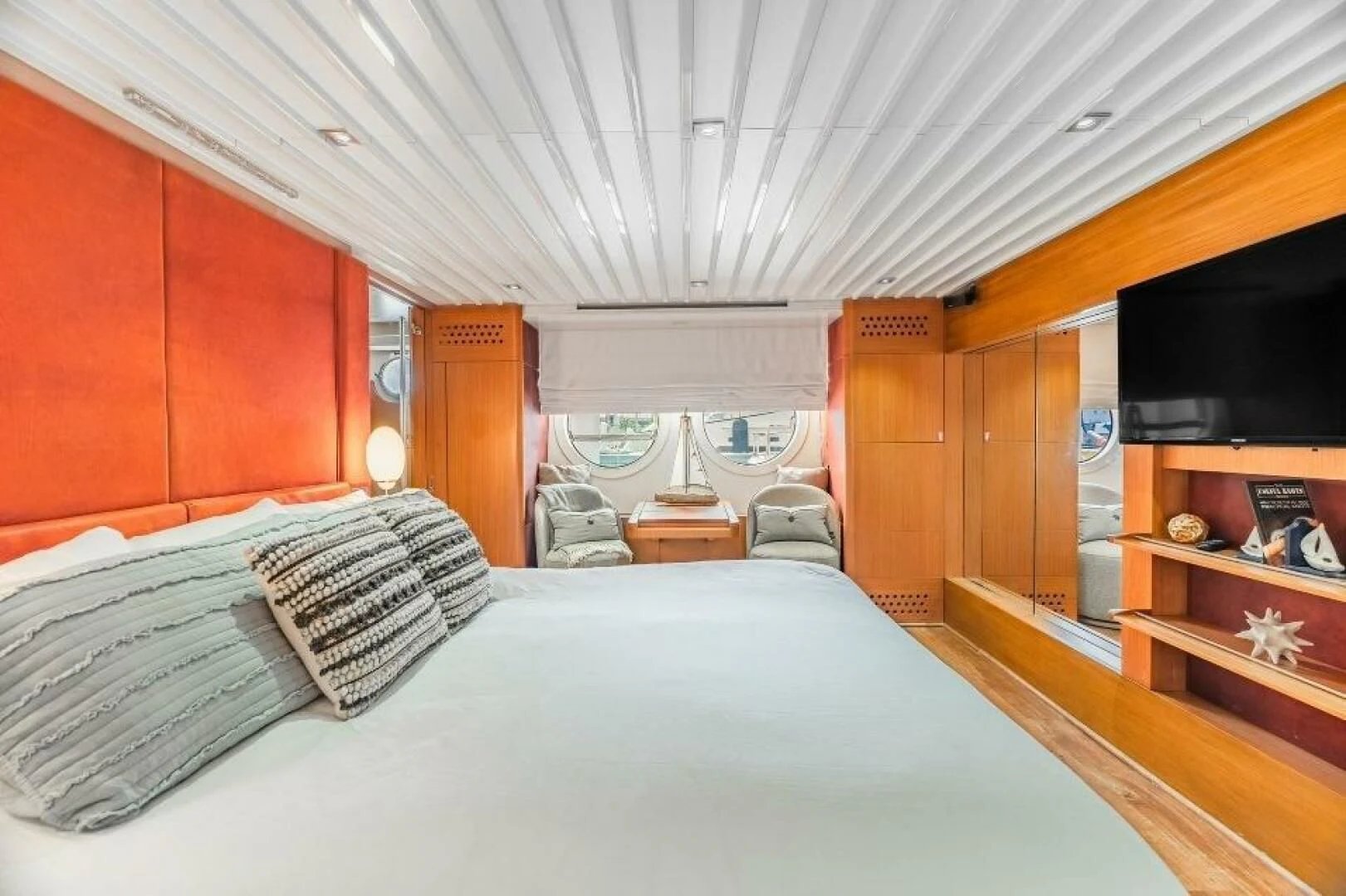 a bed with a white bed spread aboard BLUWATER Yacht for Sale