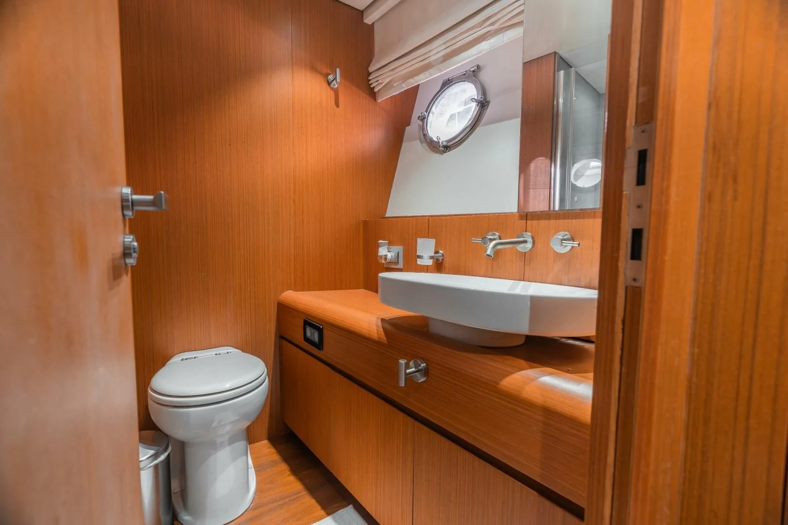 a bathroom with a toilet sink and a mirror aboard BLUWATER Yacht for Sale
