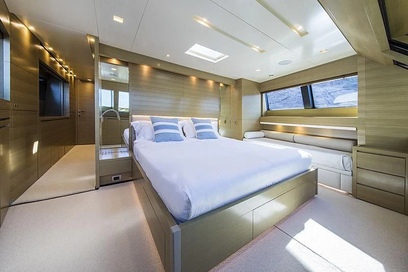 a room with a bed and a mirror aboard ELEFTHERIA Yacht for Sale