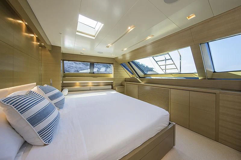 a room with a bed and a window aboard ELEFTHERIA Yacht for Sale