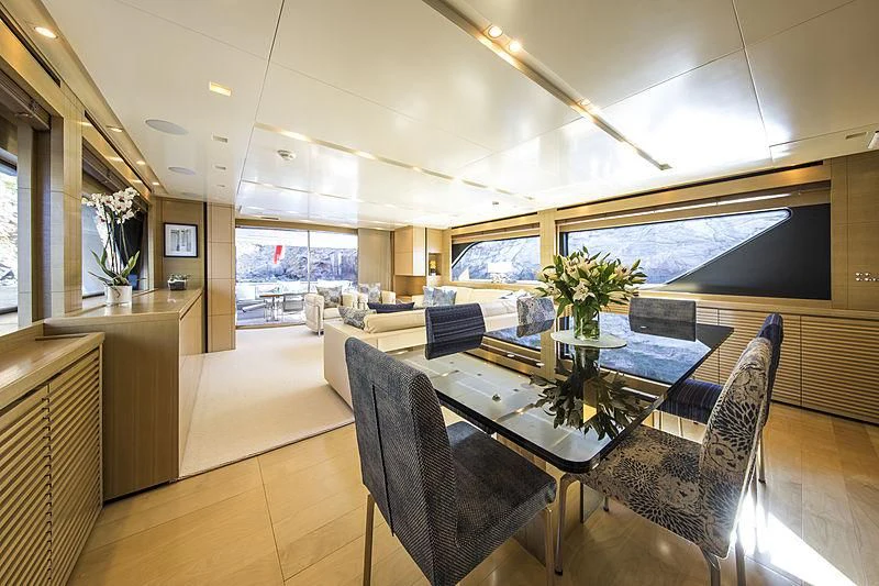 a large room with a table and chairs aboard ELEFTHERIA Yacht for Sale