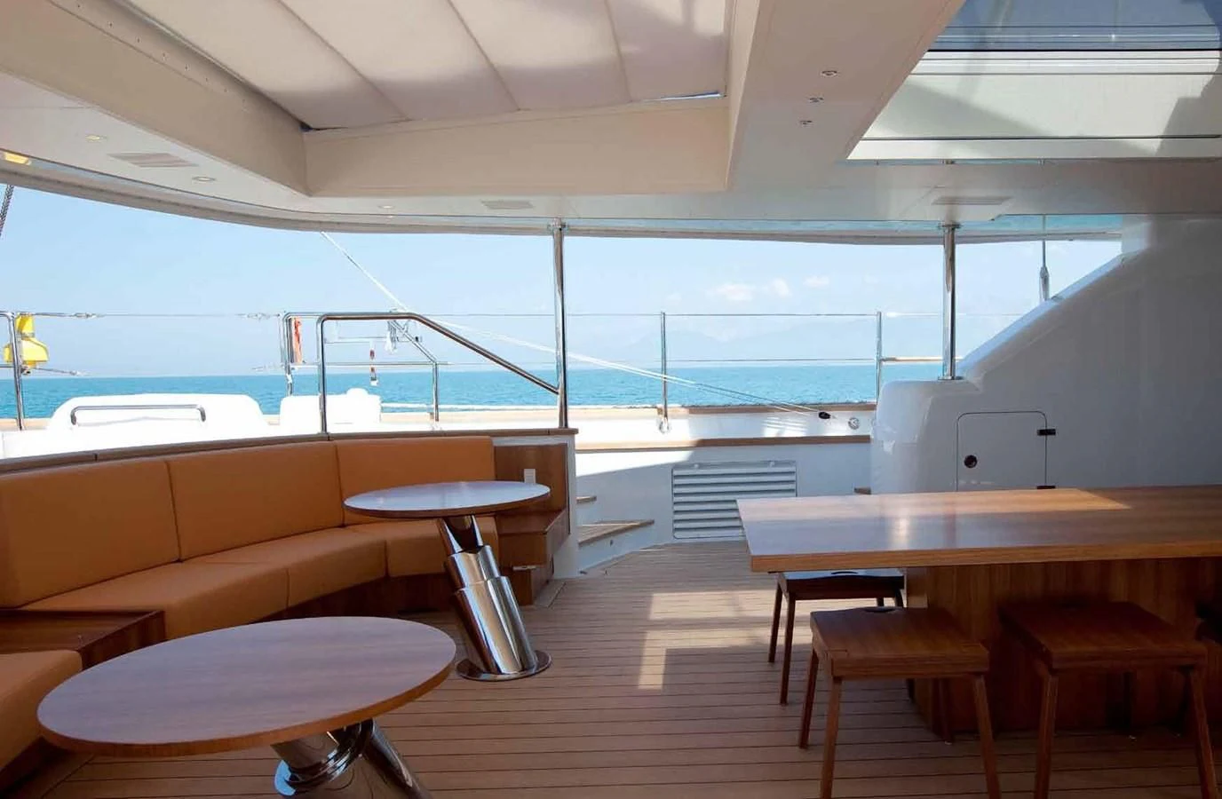 a room with tables and chairs aboard ENTERPRISE Yacht for Sale