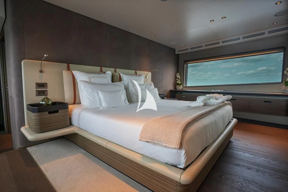 a room with a bed and a window aboard JYC Yacht for Sale