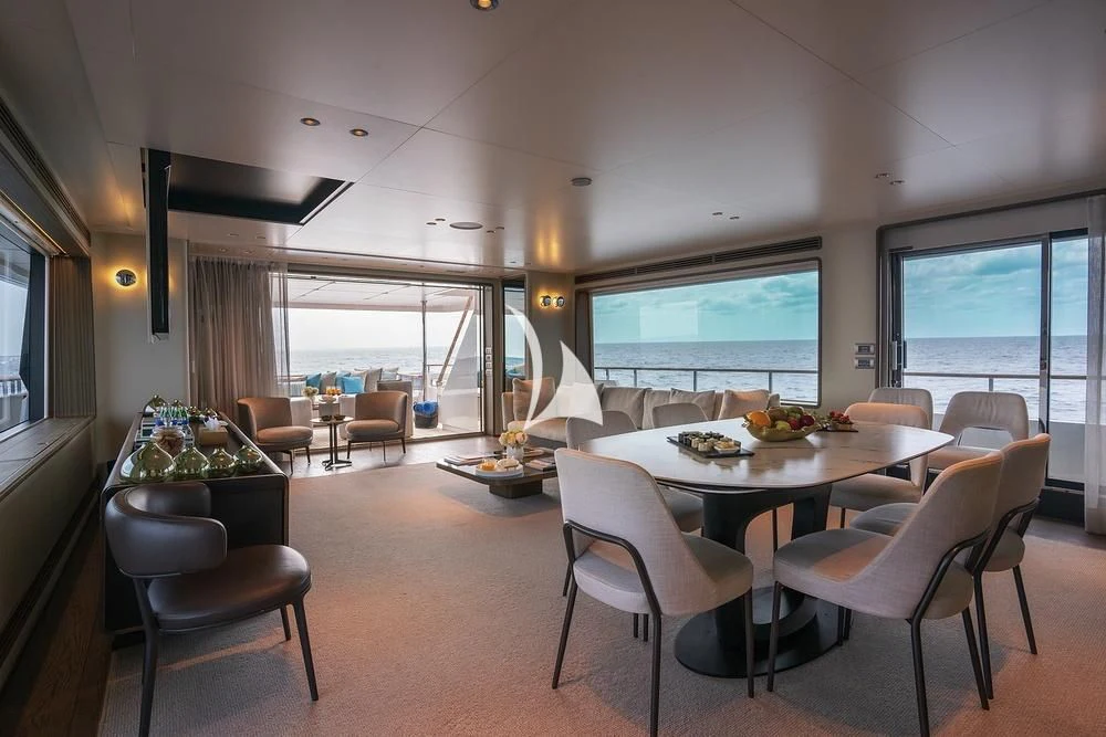 a dining room with a large window aboard JYC Yacht for Sale