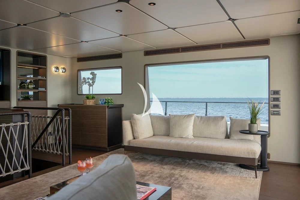 a living room with a large window aboard JYC Yacht for Sale