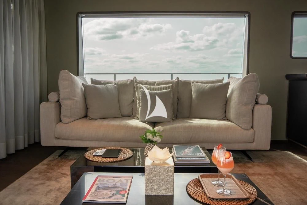 a living room with a large window aboard JYC Yacht for Sale