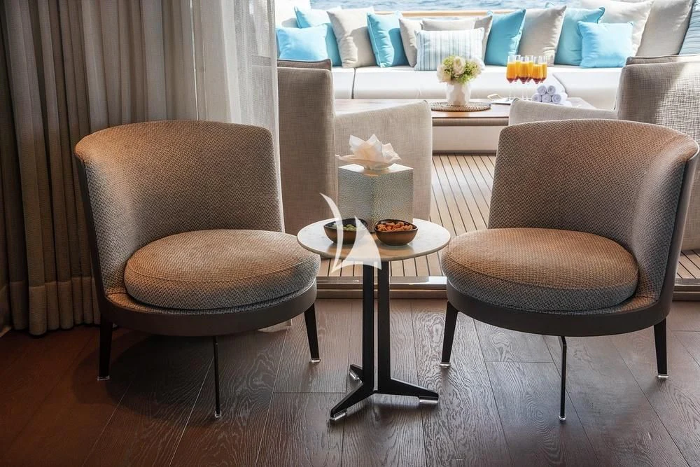 a couple of chairs next to a table with food on it aboard JYC Yacht for Sale