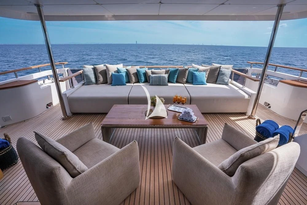 a living room with a large balcony aboard JYC Yacht for Sale