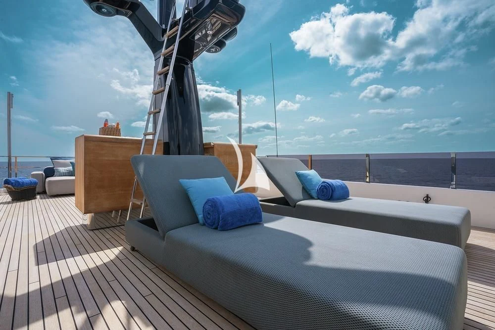 a large bed on a deck aboard JYC Yacht for Sale