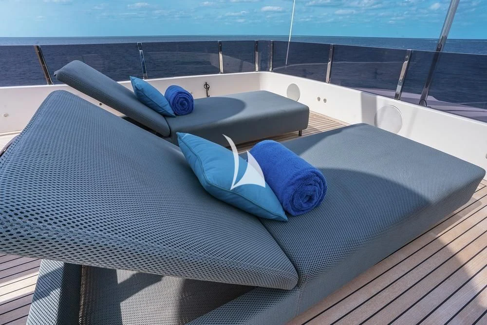 a lounge chair on a deck aboard JYC Yacht for Sale