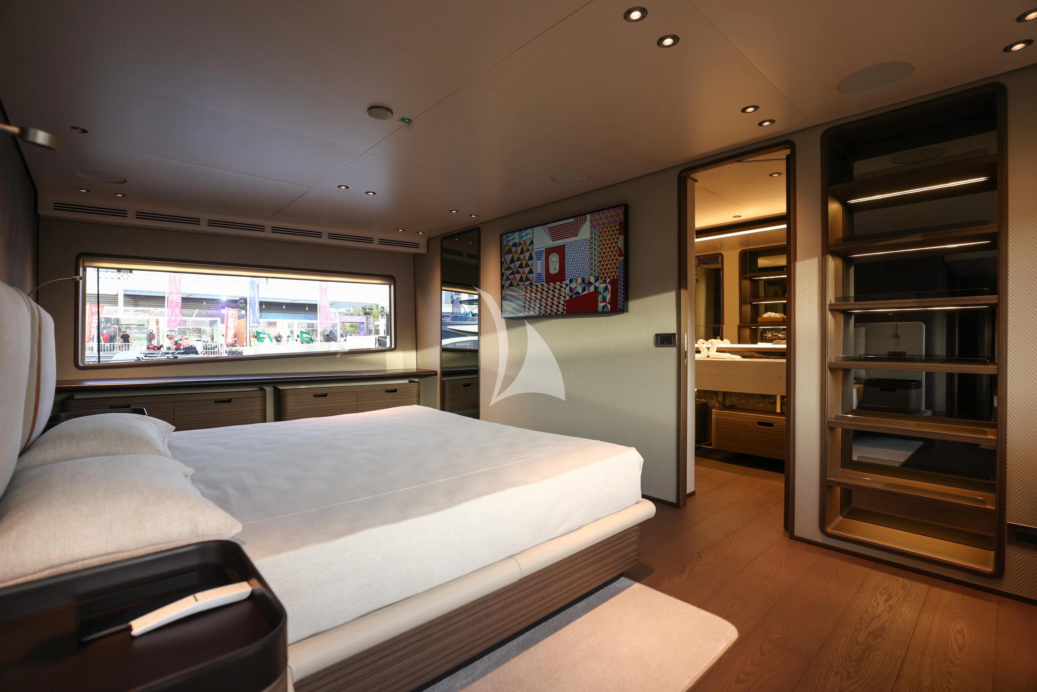 a bedroom with a bed and a large mirror aboard JYC Yacht for Sale