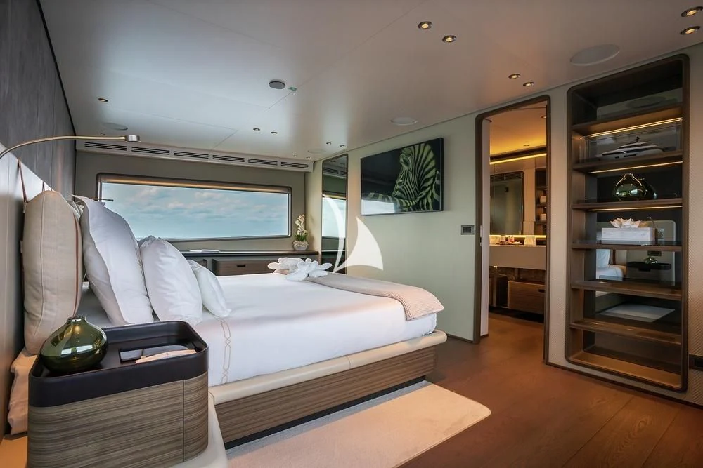 a bedroom with a large bed aboard JYC Yacht for Sale