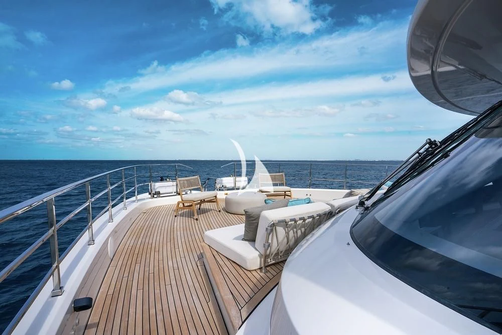 a deck with a view of the ocean and a boat on it aboard JYC Yacht for Sale