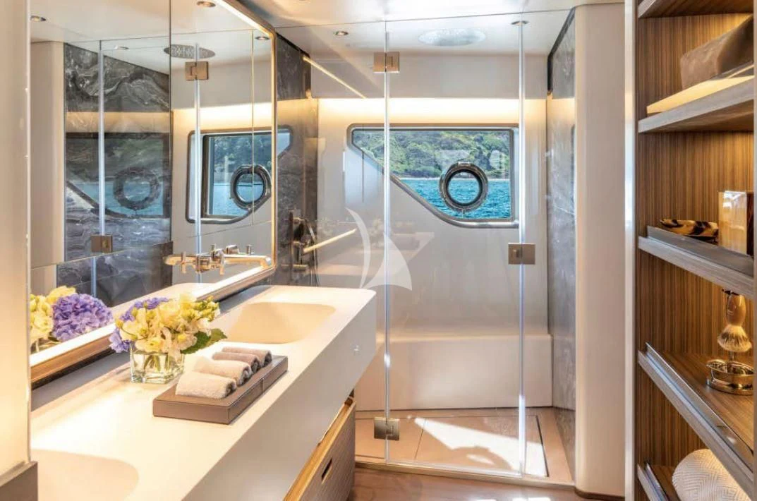 a bathroom with a glass shower aboard JYC Yacht for Sale