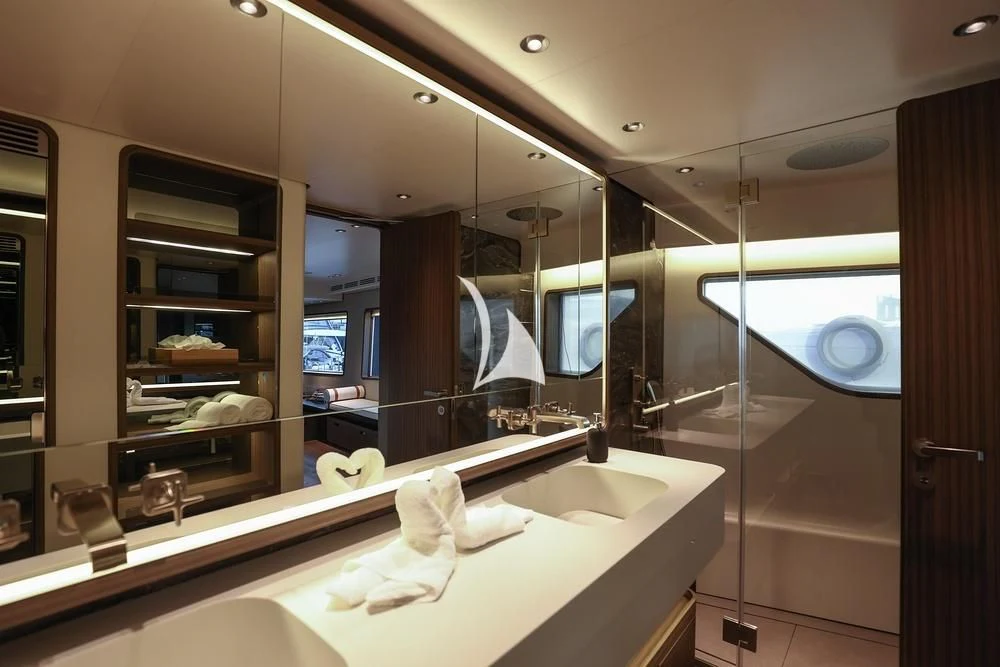 a bathroom with a large mirror aboard JYC Yacht for Sale