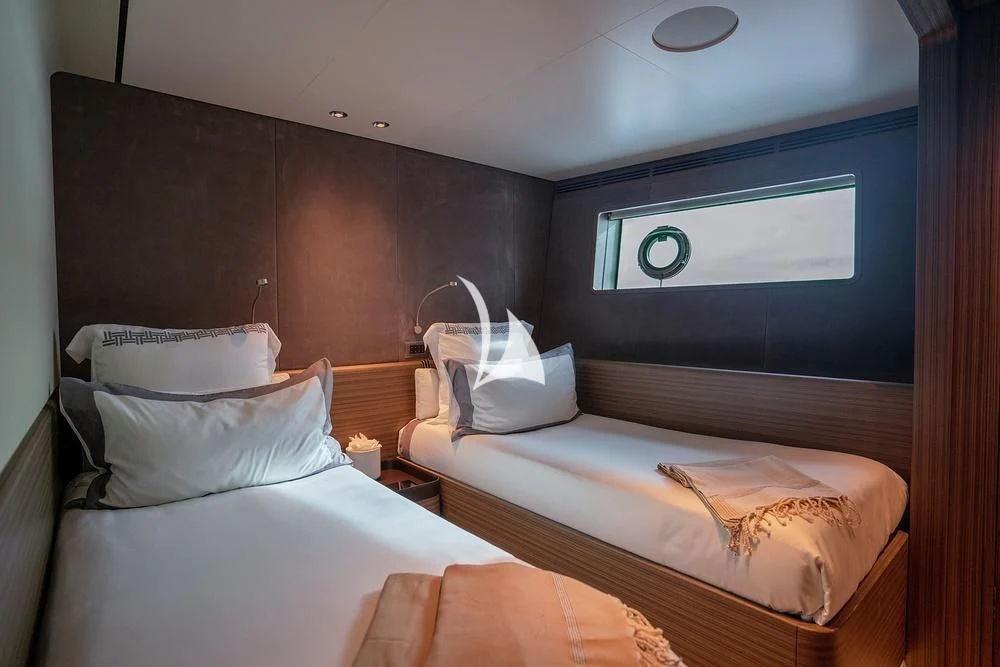 a room with two beds aboard JYC Yacht for Sale