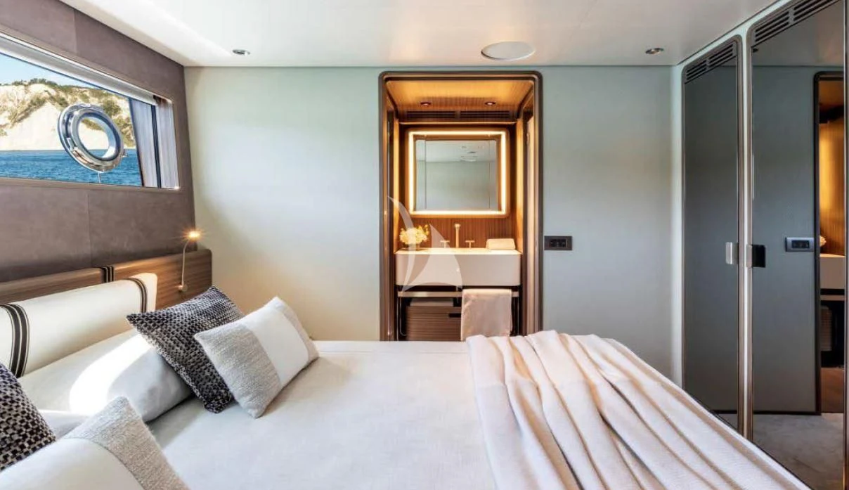 a hotel room with a bed and a table aboard JYC Yacht for Sale