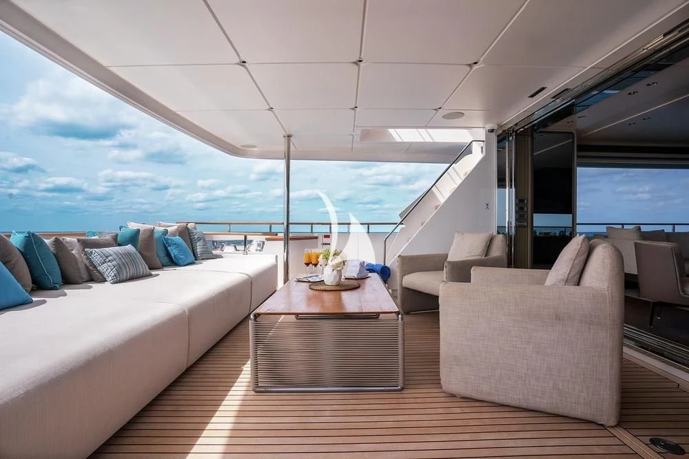 a room with a table and chairs aboard JYC Yacht for Sale