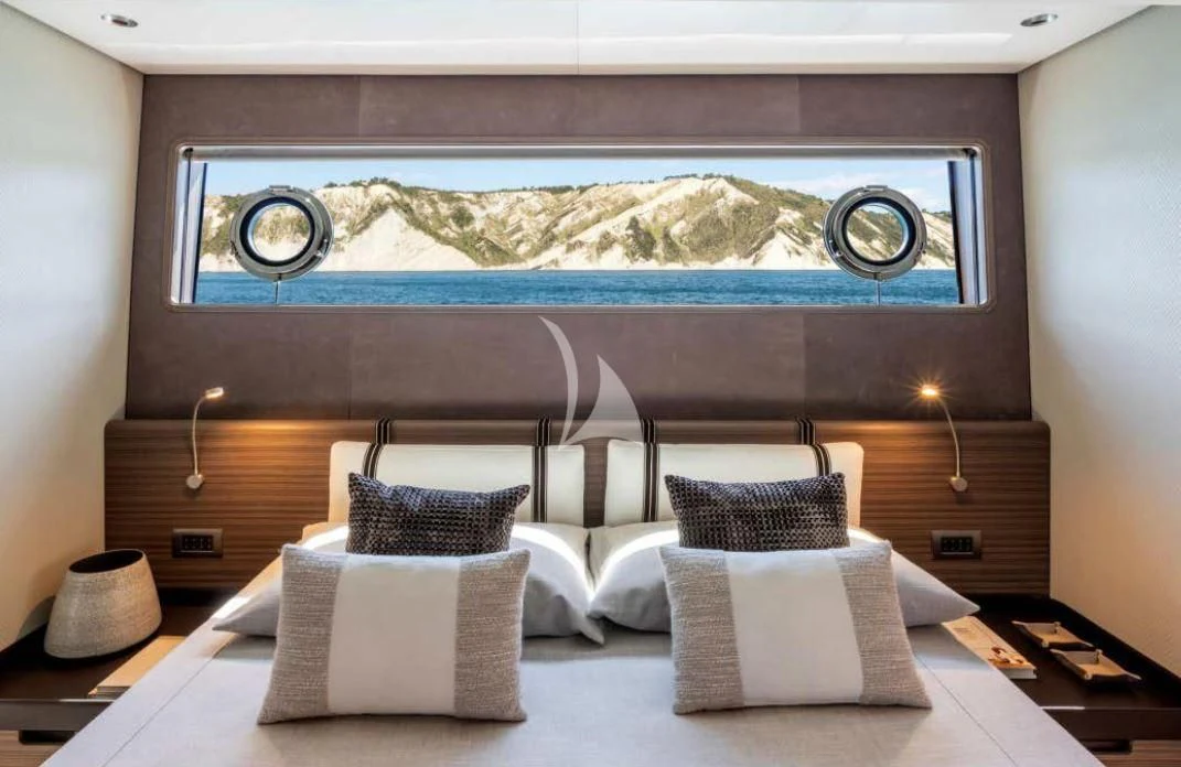 a large bed with a large painting above it aboard JYC Yacht for Sale