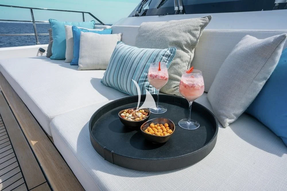 a table with a bowl of fruit and glasses on it aboard JYC Yacht for Sale