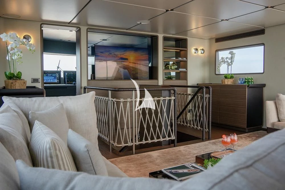 a living room with a white couch and a black and white rug aboard JYC Yacht for Sale