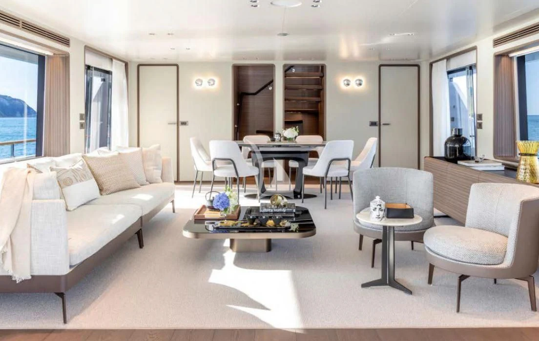 a living room with a couch and a coffee table aboard JYC Yacht for Sale