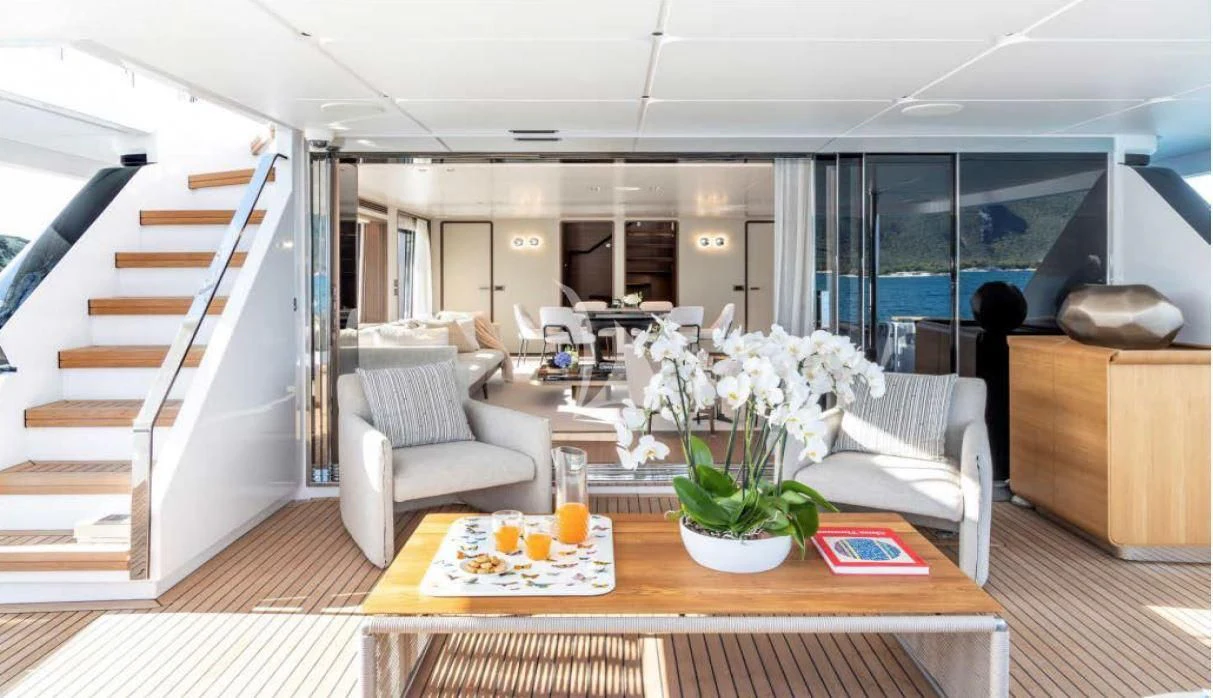 a living room with a table and chairs aboard JYC Yacht for Sale