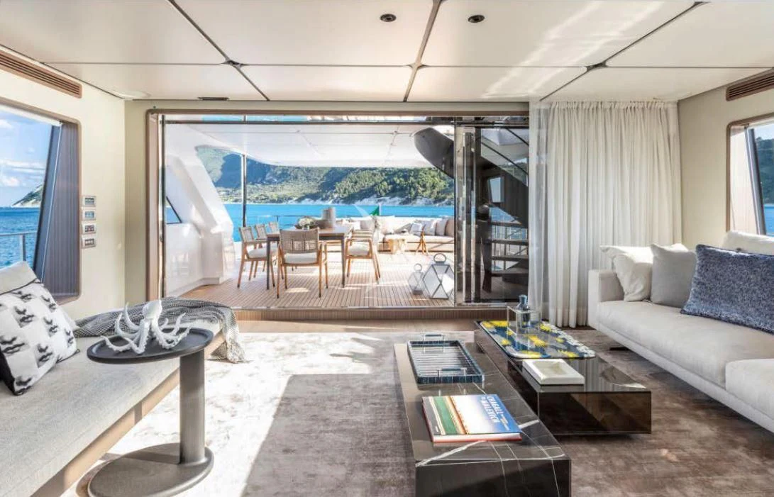a living room with a large balcony aboard JYC Yacht for Sale