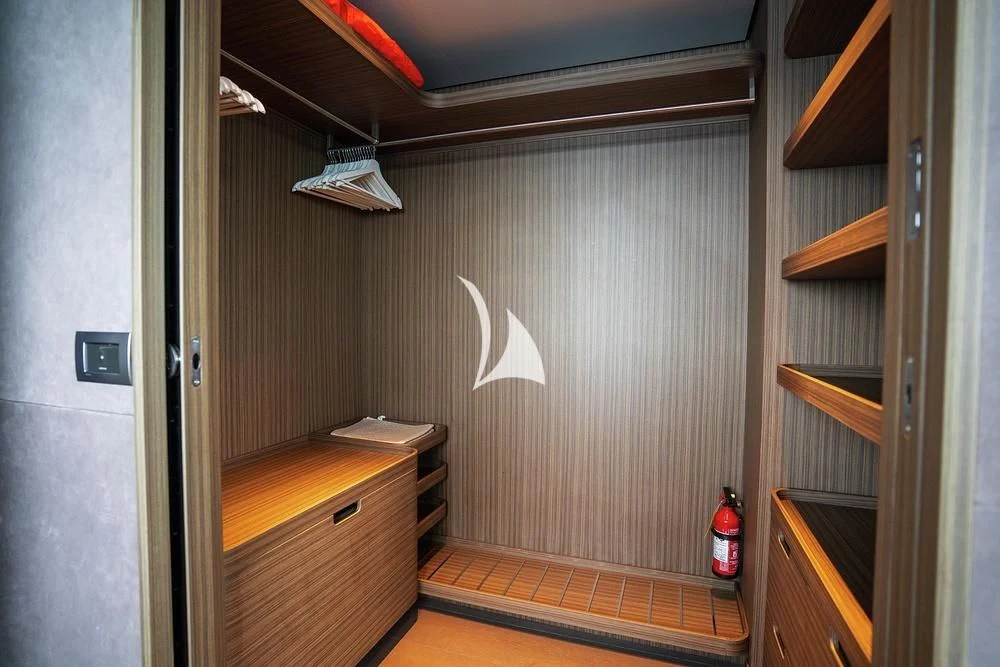 a room with a wood cabinet and a white bird on a wall aboard JYC Yacht for Sale