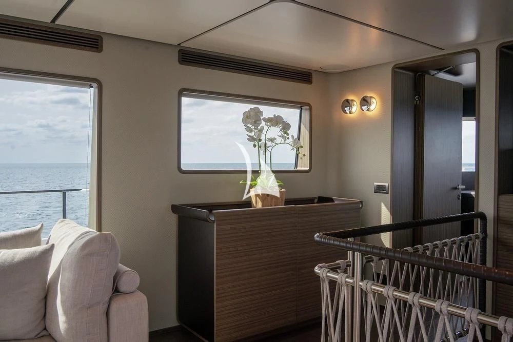 a living room with a balcony aboard JYC Yacht for Sale
