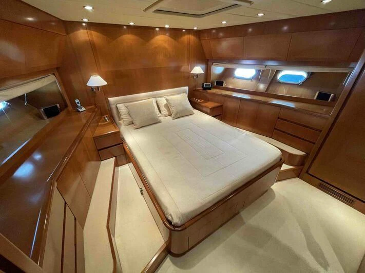 a room with a bed and a table aboard TOBEKA Yacht for Sale