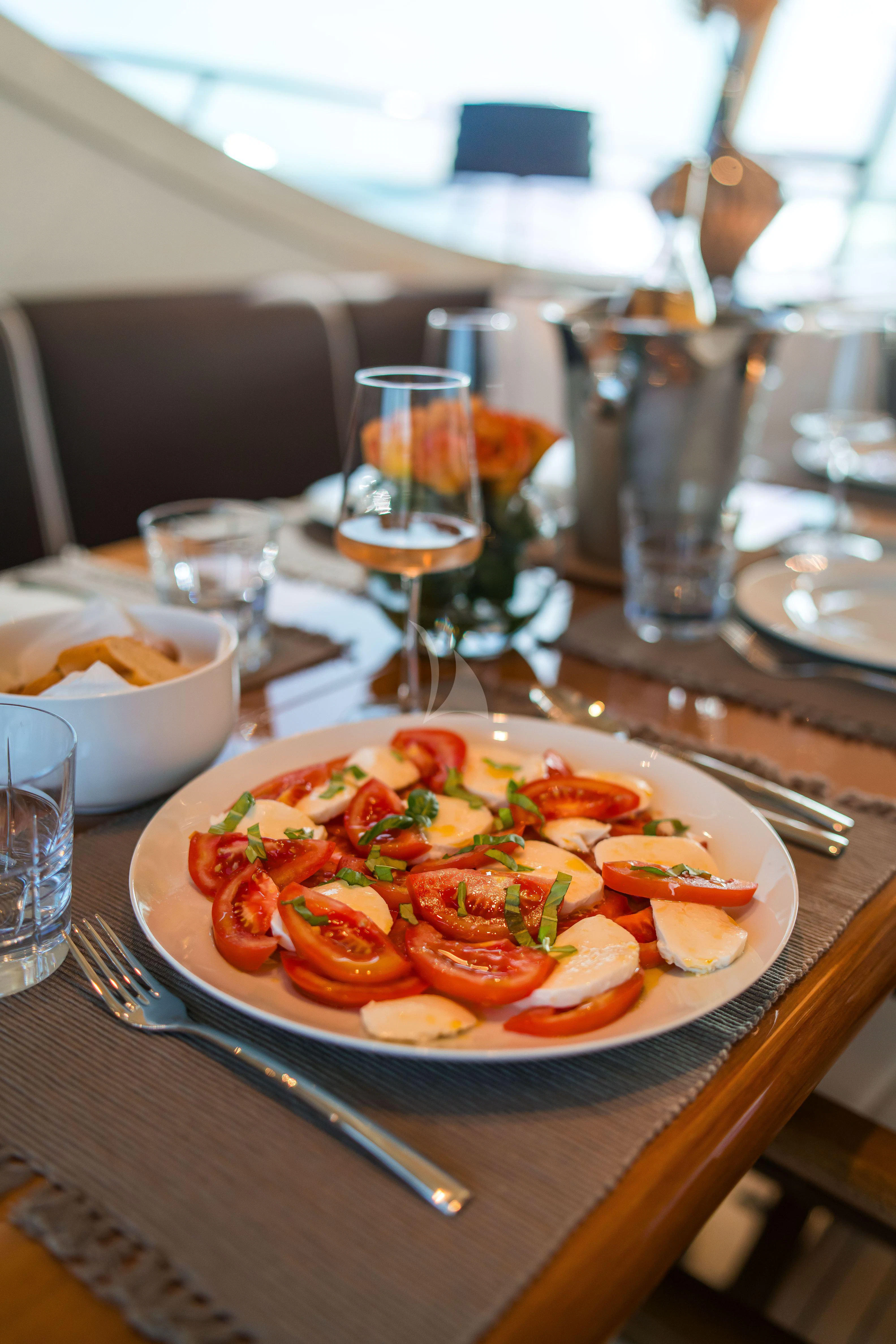 a plate of food on a table aboard TOBEKA Yacht for Sale