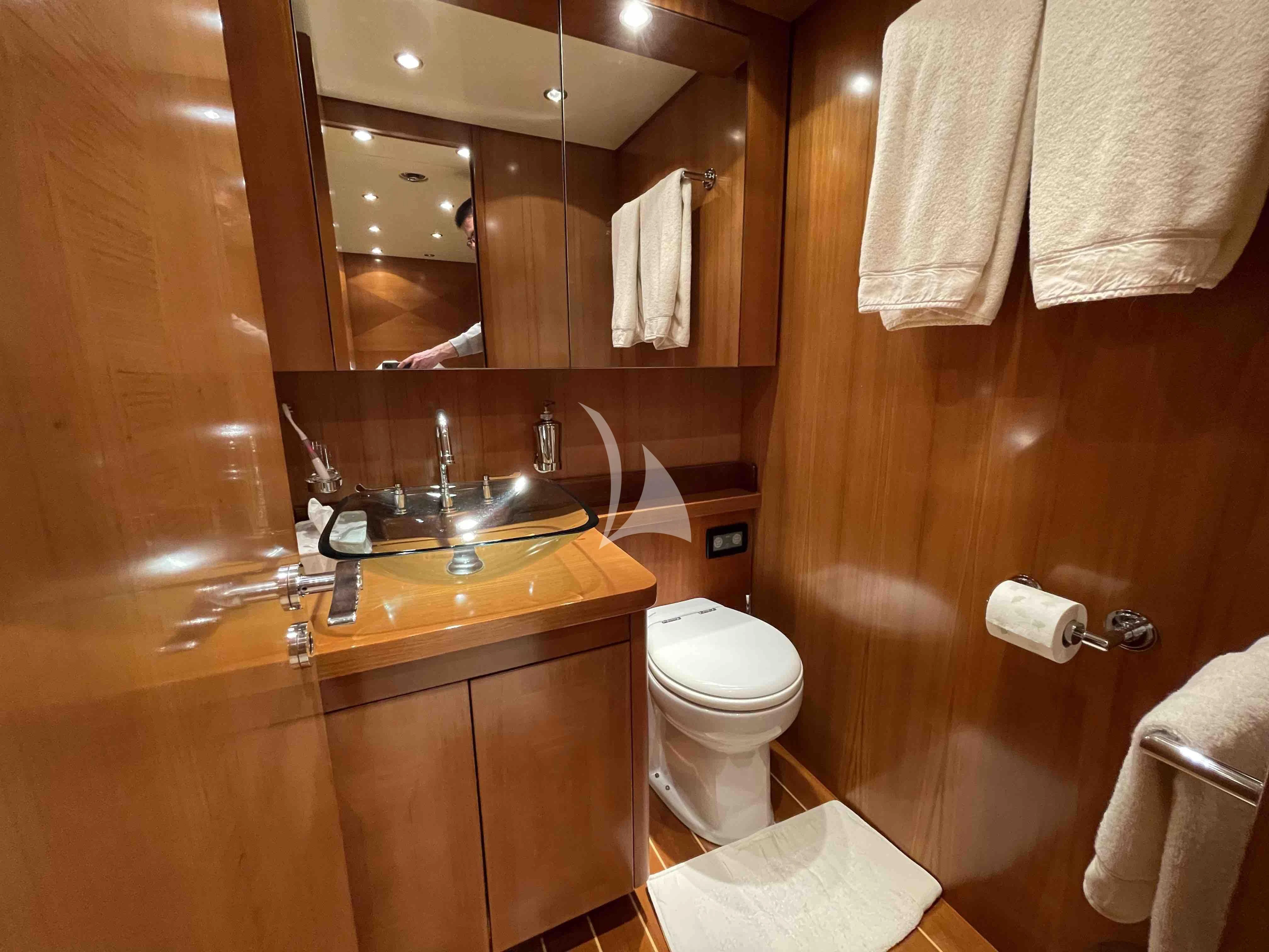 a bathroom with a toilet and a mirror aboard TOBEKA Yacht for Sale