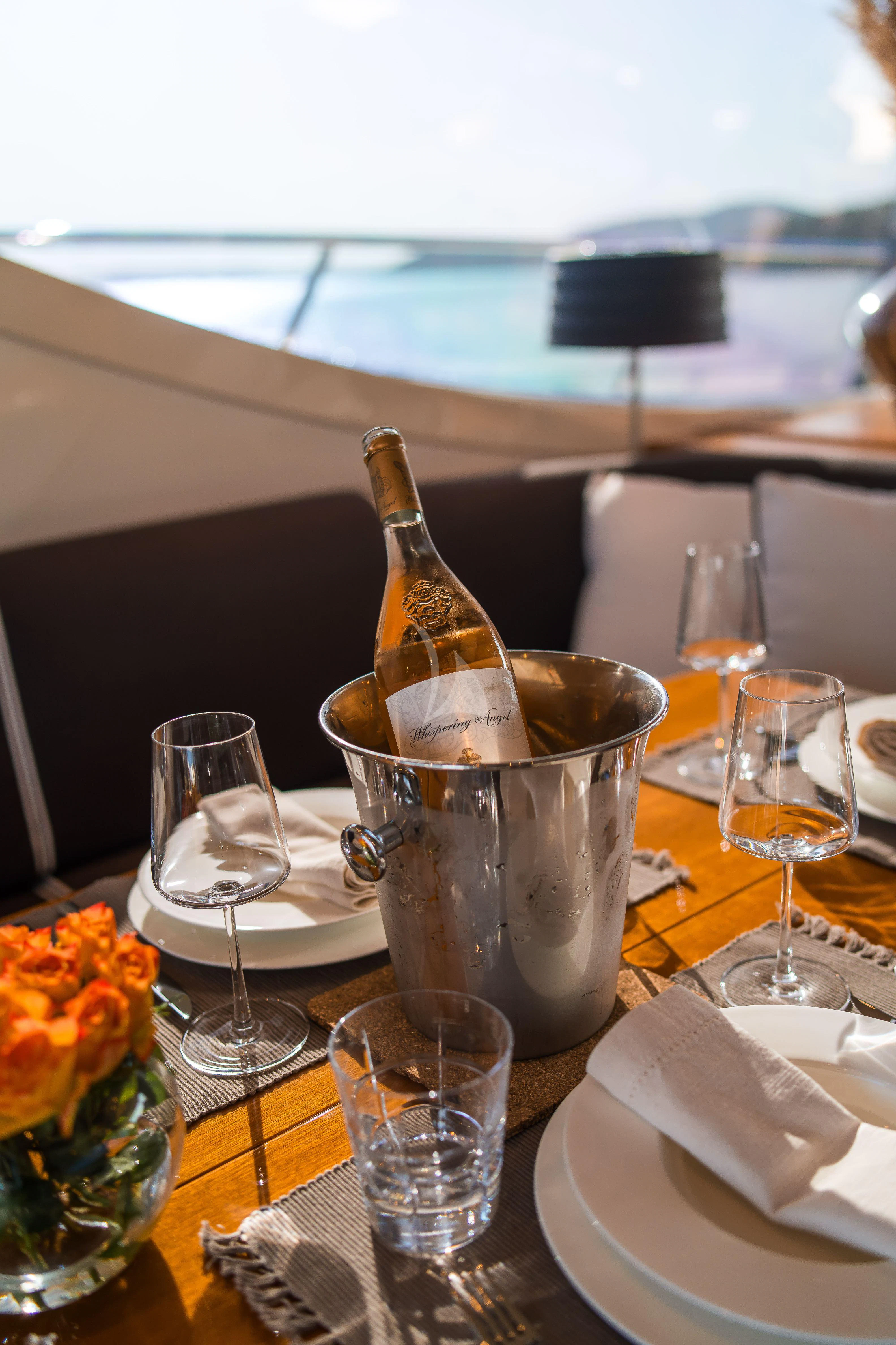 a bottle of wine on a table aboard TOBEKA Yacht for Sale