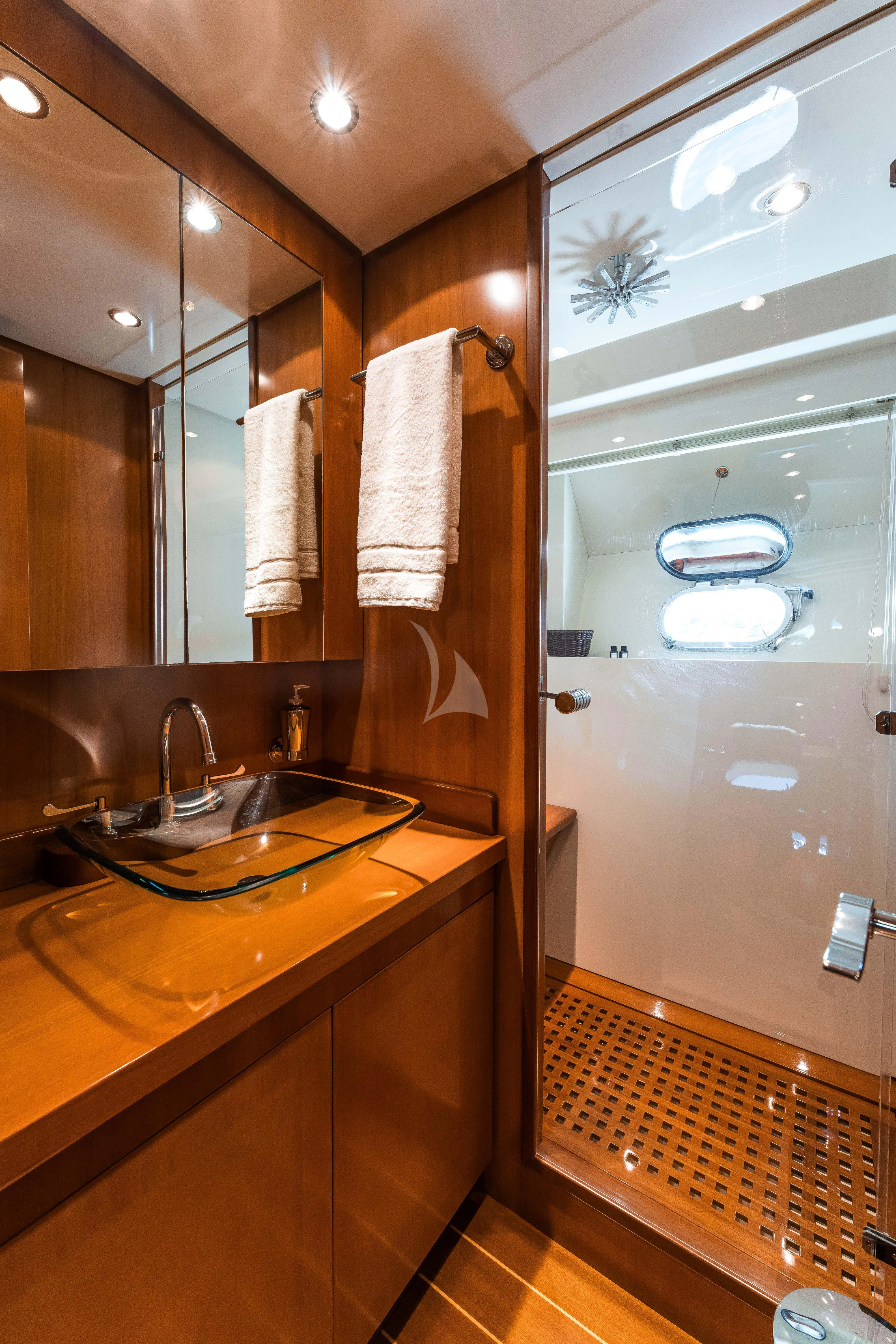 a bathroom with a glass shower aboard TOBEKA Yacht for Sale