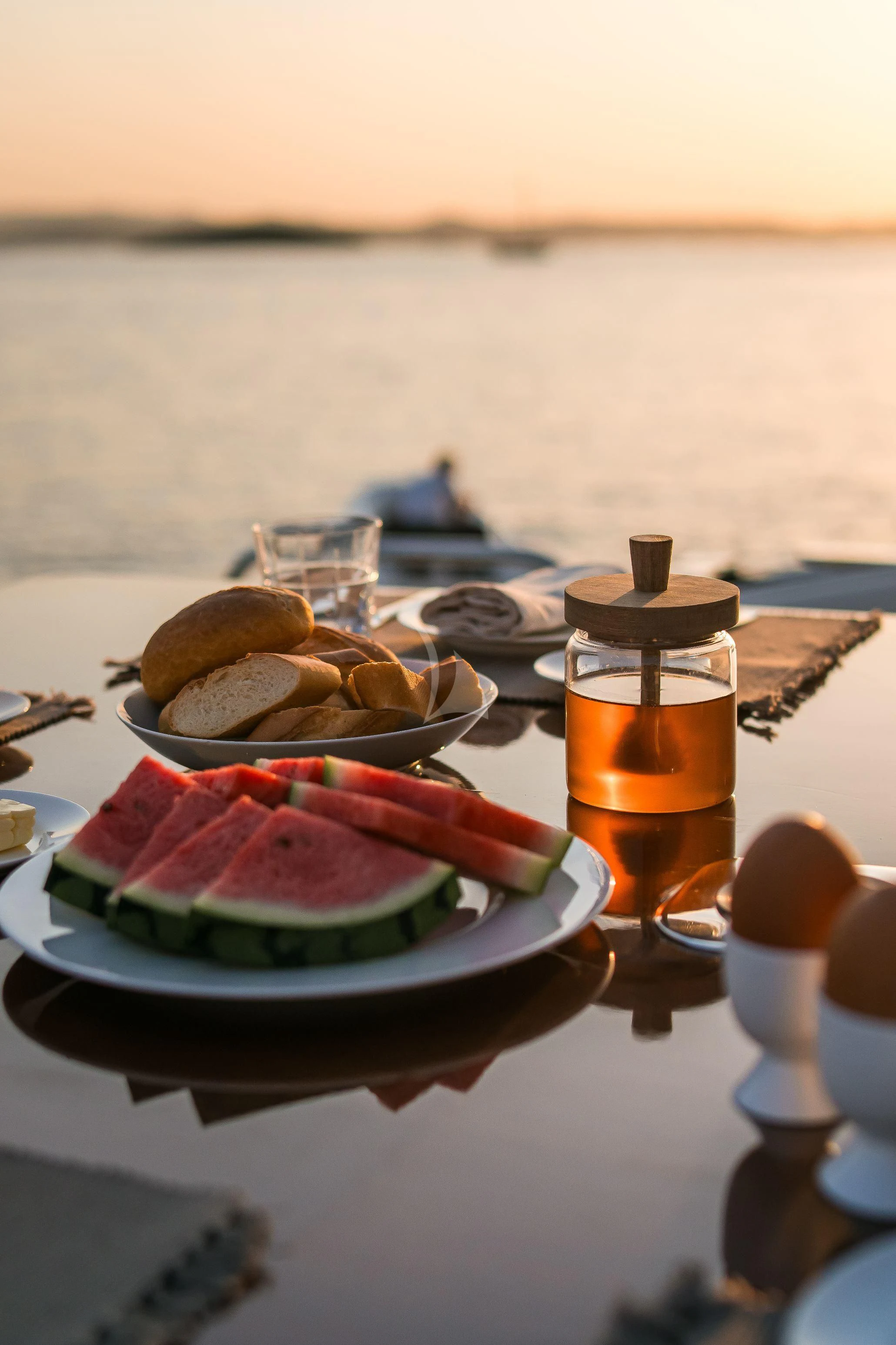 a plate of food and a glass of juice on a table aboard TOBEKA Yacht for Sale