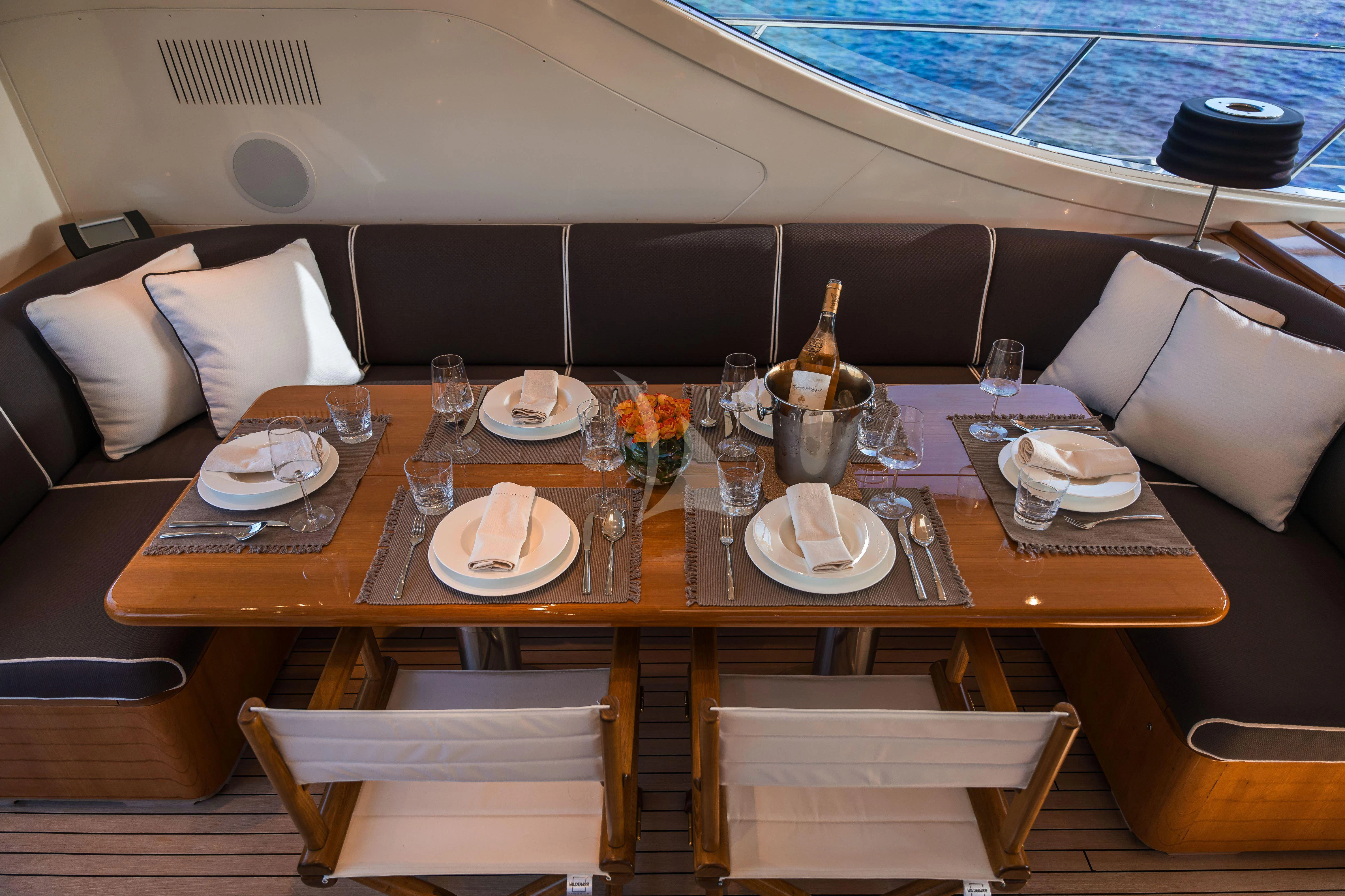 a table with plates and glasses on it aboard TOBEKA Yacht for Sale