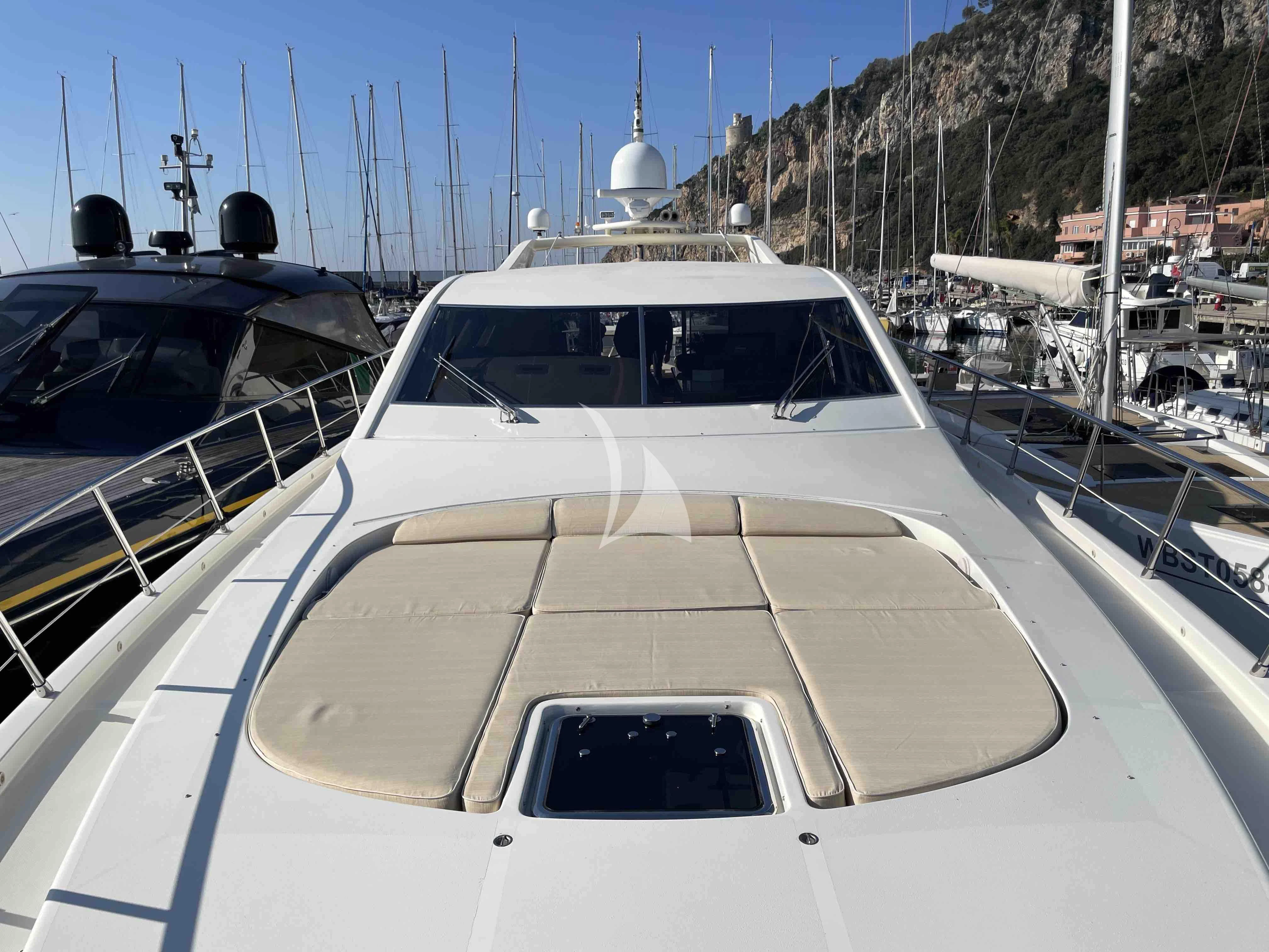 a white yacht in a harbor aboard TOBEKA Yacht for Sale