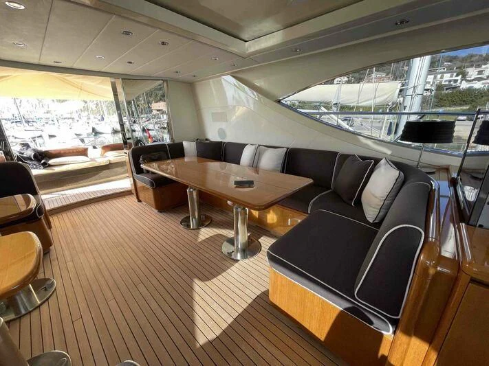 a room with a table and couches aboard TOBEKA Yacht for Sale