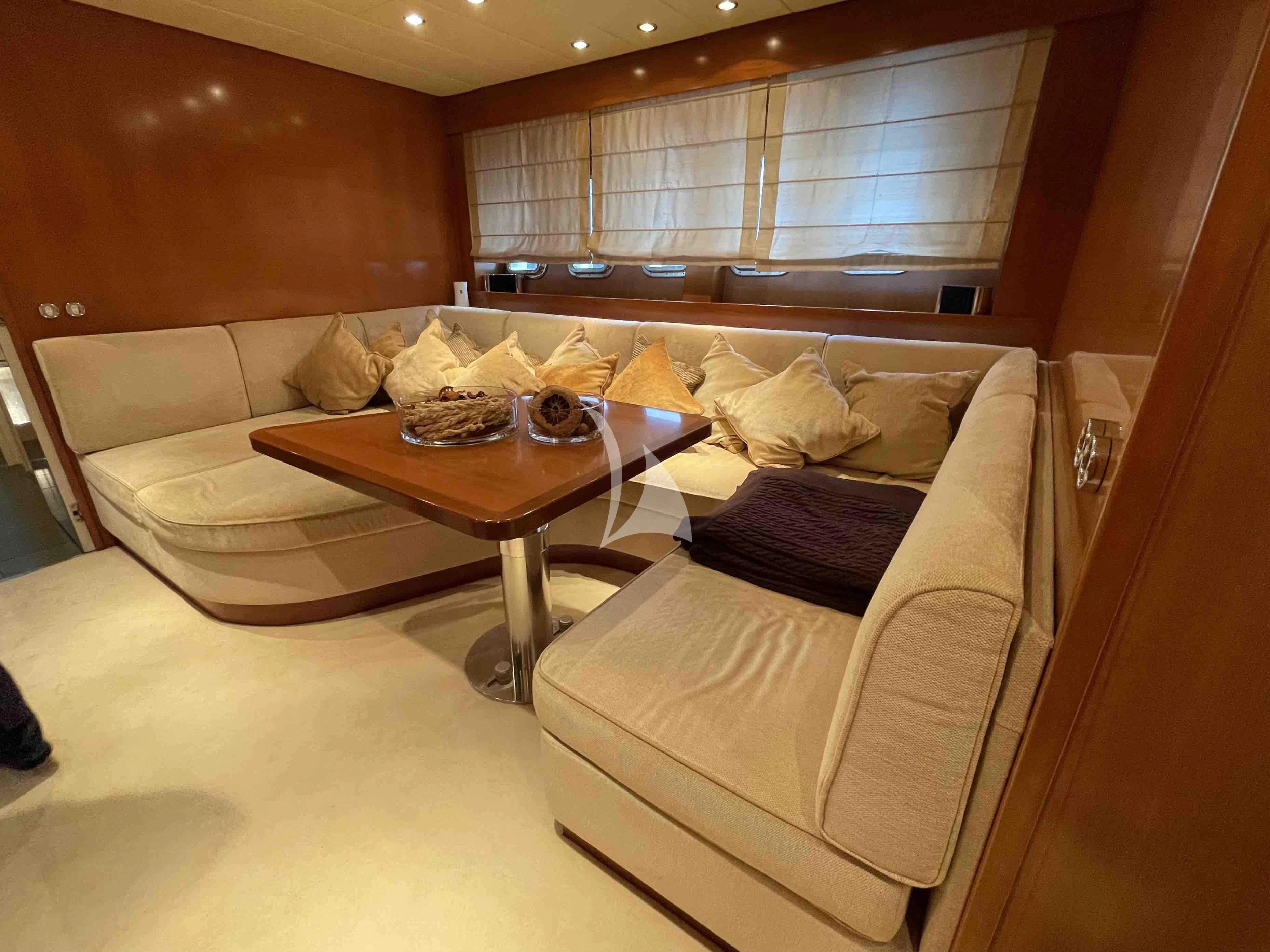 a living room with a couch and coffee table aboard TOBEKA Yacht for Sale