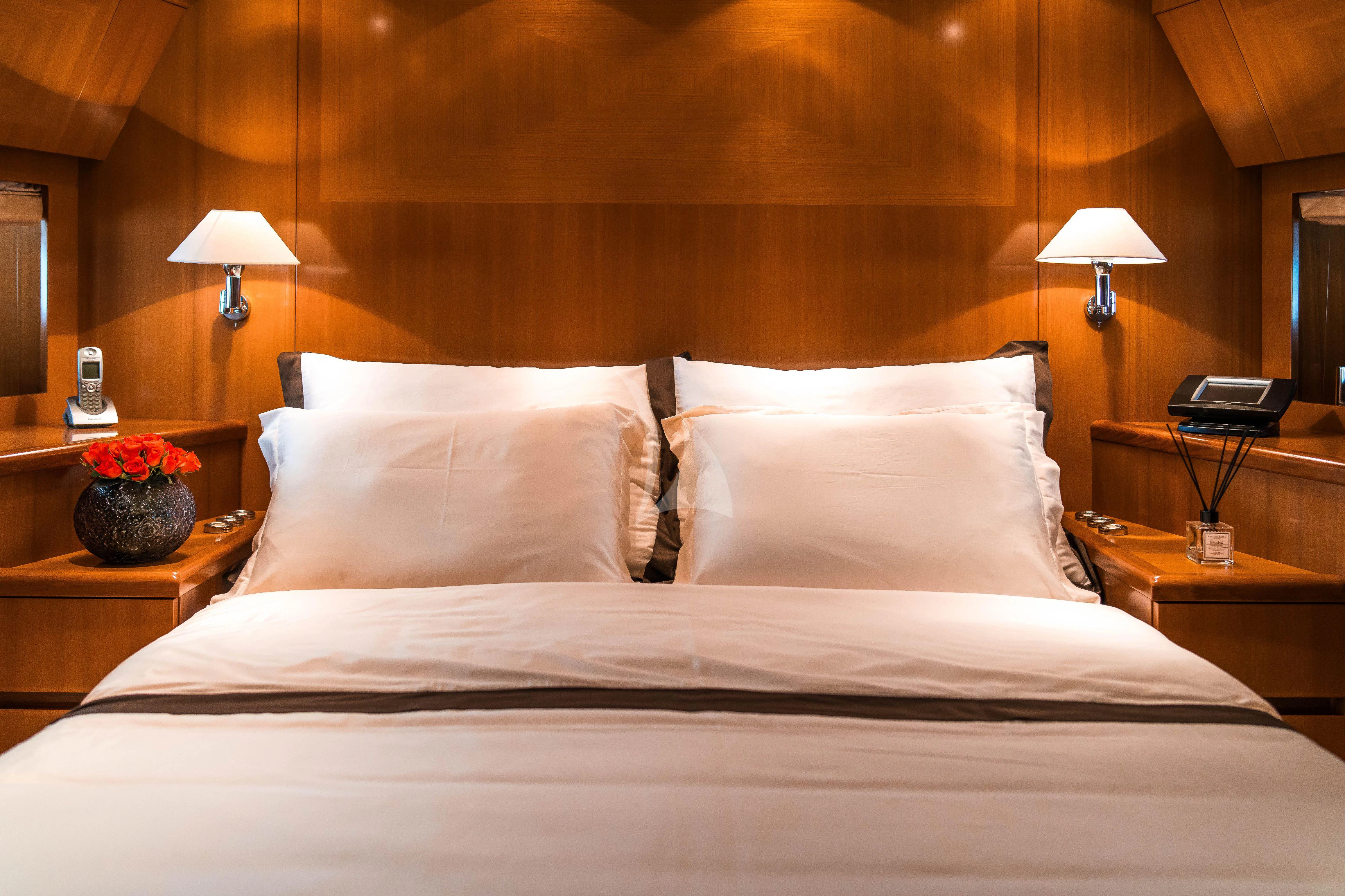 a bed with white pillows aboard TOBEKA Yacht for Sale