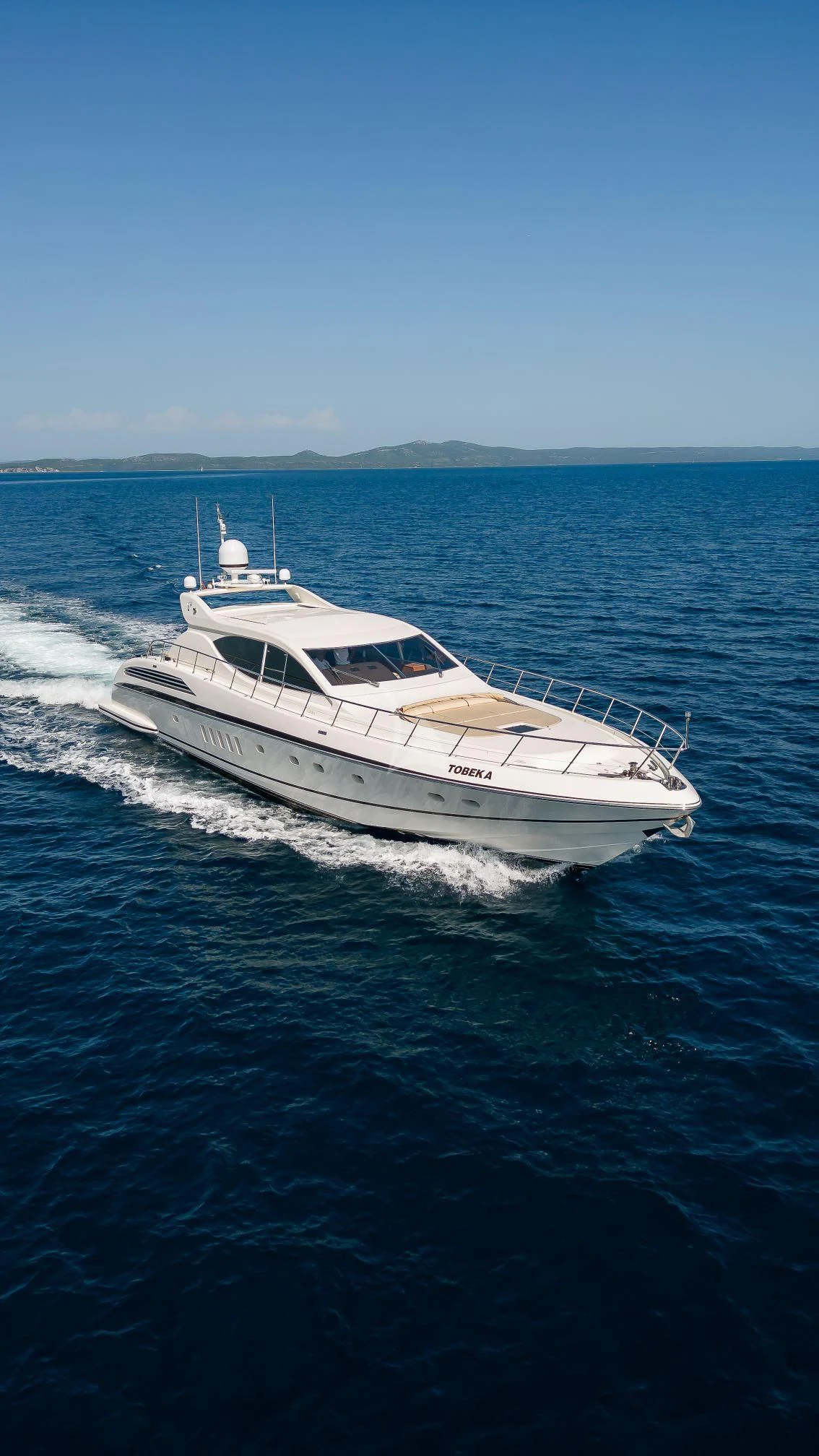 a white boat on the water aboard TOBEKA Yacht for Sale