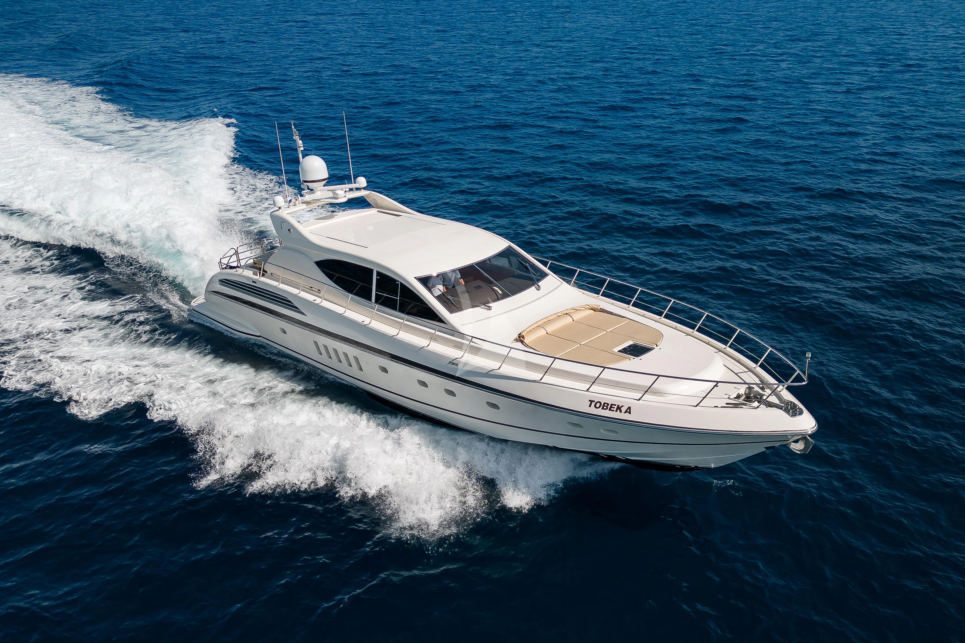 a white yacht on the water aboard TOBEKA Yacht for Sale