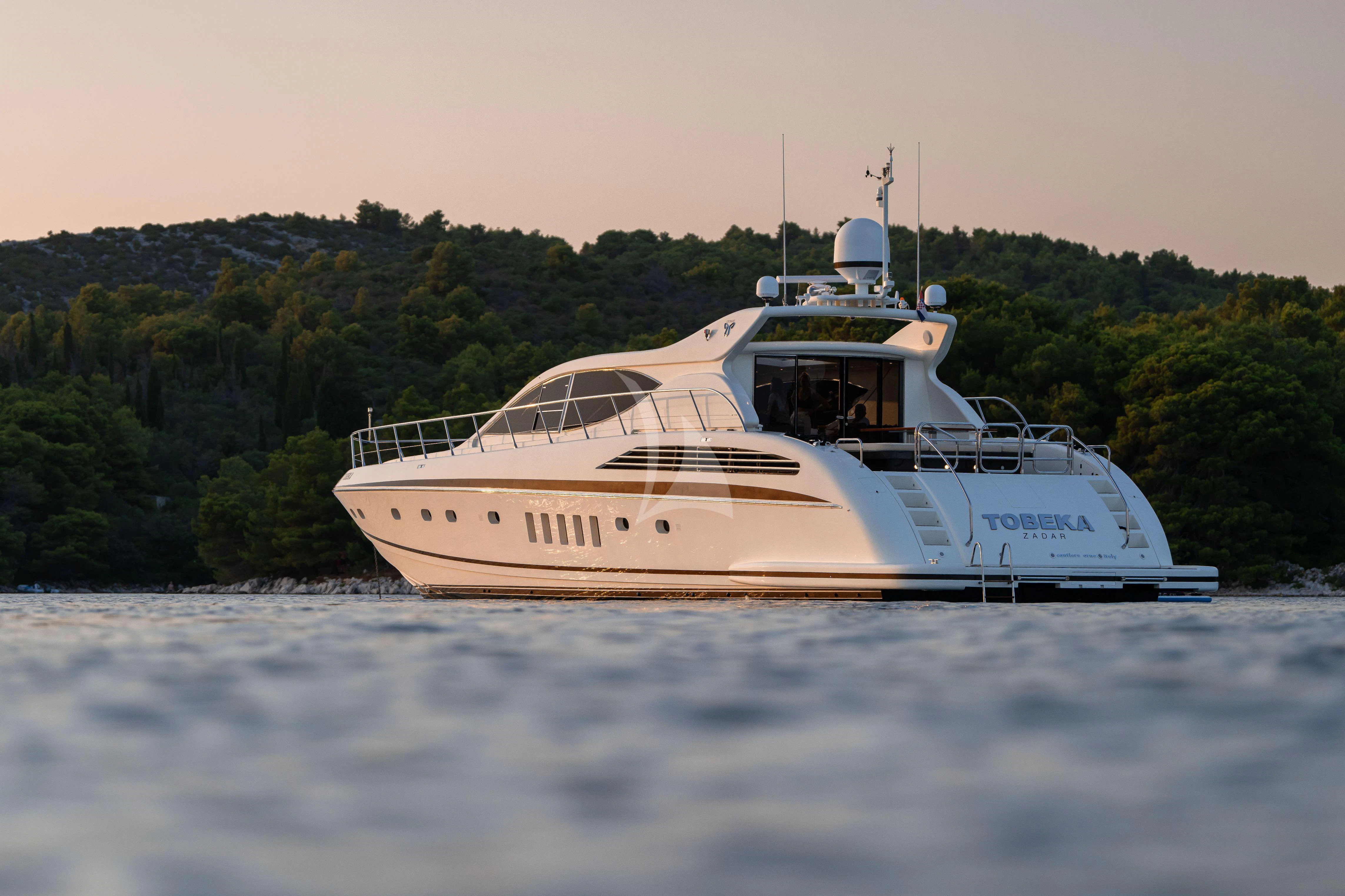 a white boat on water aboard TOBEKA Yacht for Sale