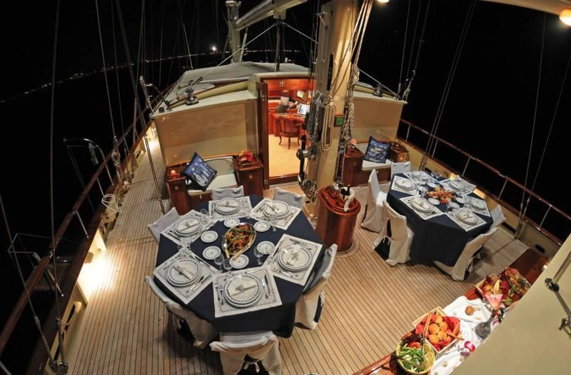 a room with a table and chairs aboard OFELIA Yacht for Sale