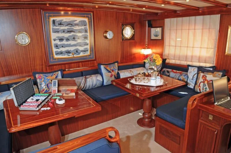 a living room with a couch and a coffee table aboard OFELIA Yacht for Sale