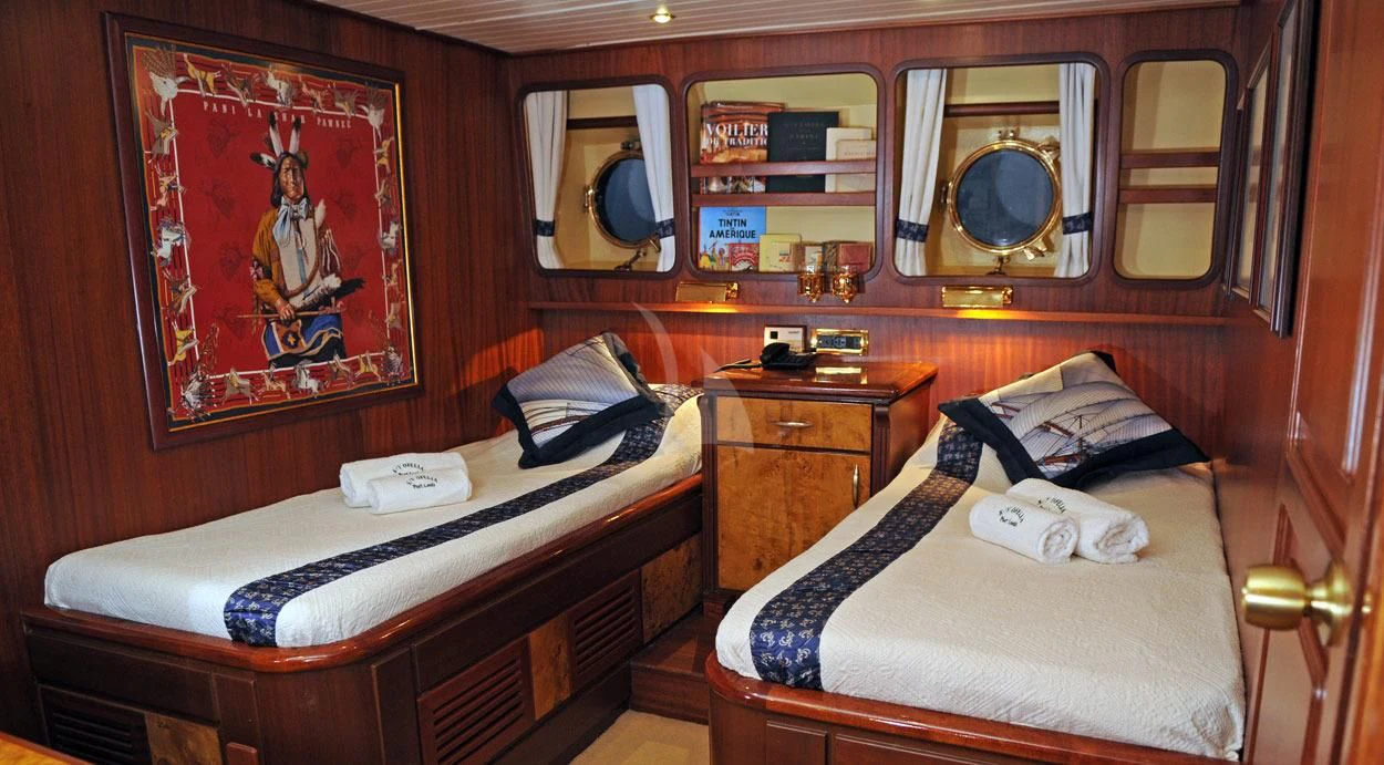 a room with a bed and a mirror aboard OFELIA Yacht for Sale