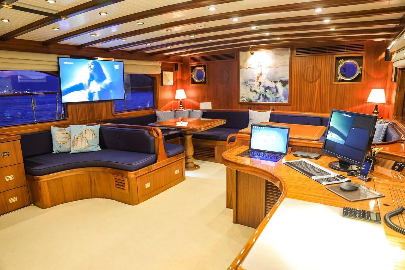 a living room with a laptop and a tv aboard OFELIA Yacht for Sale