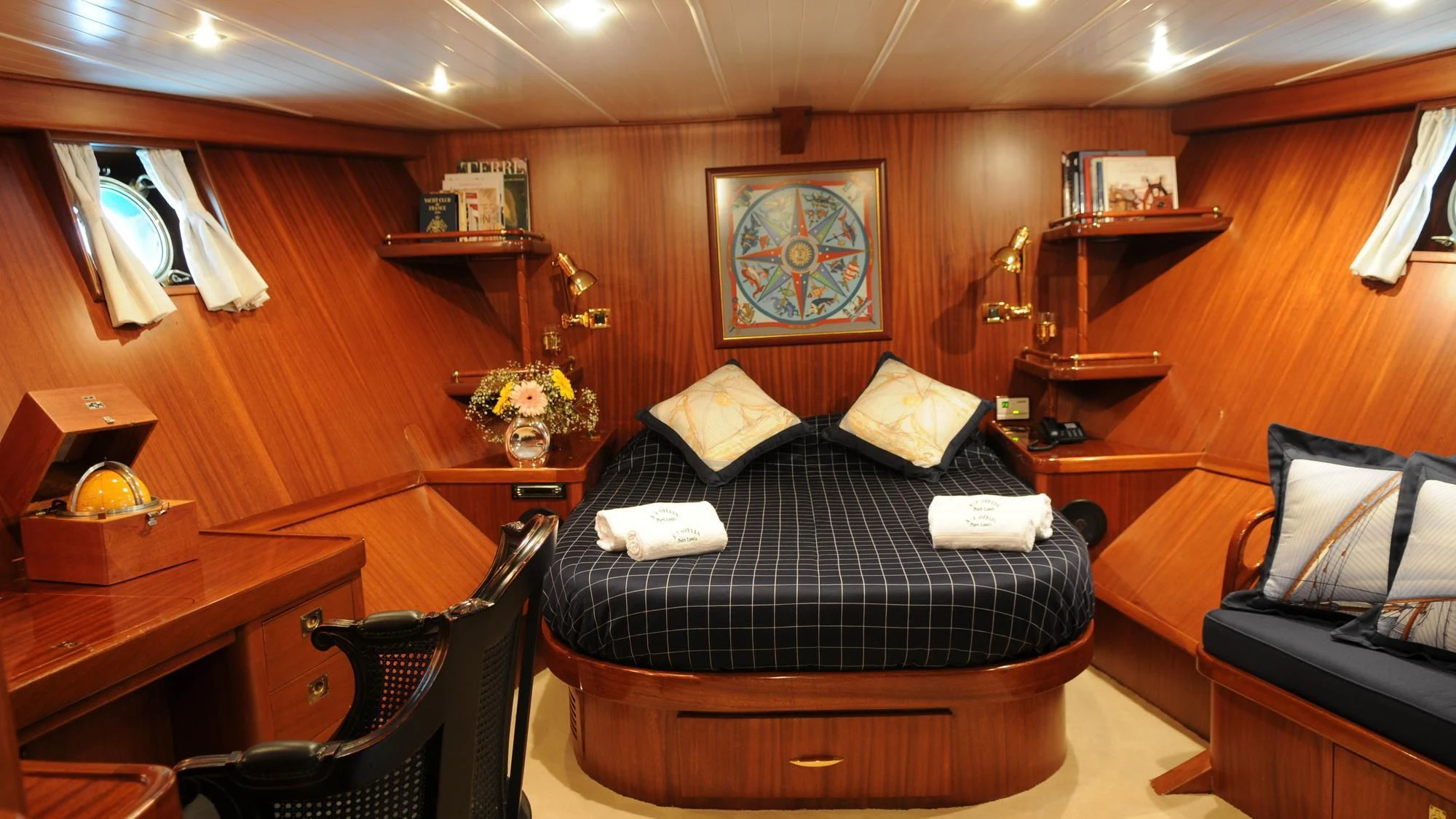 a room with a bed and a desk aboard OFELIA Yacht for Sale