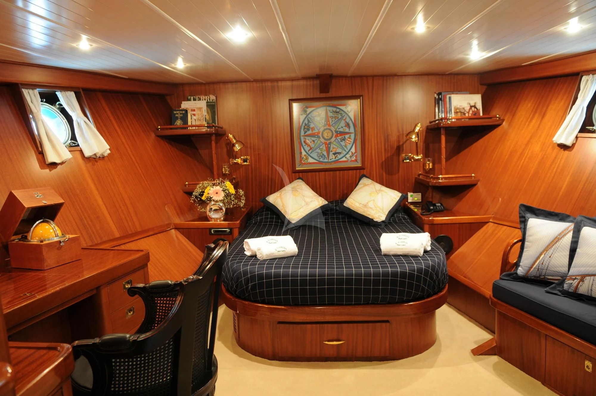 a room with a bed and a desk aboard OFELIA Yacht for Sale
